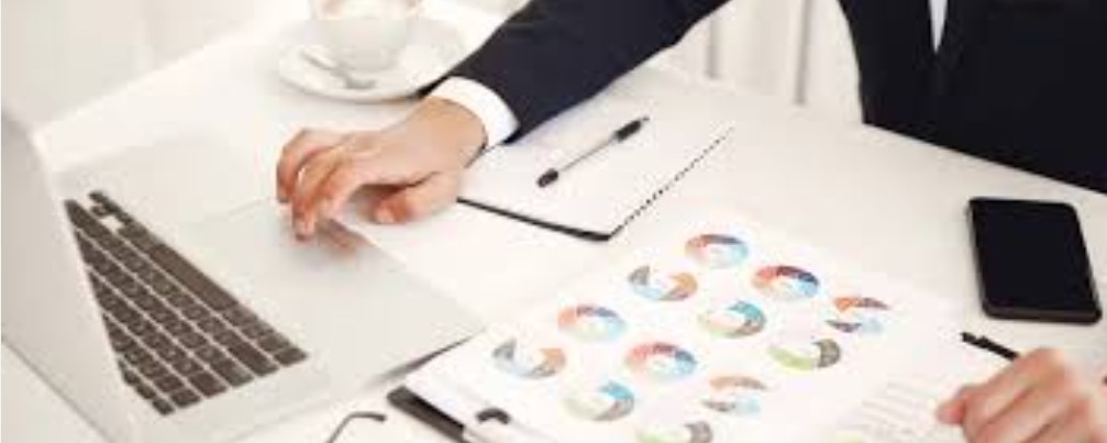 person with papers at desk